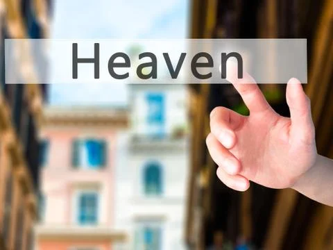 Heaven - Hand pressing a button on blurred background concept on visual scree Stock Photos