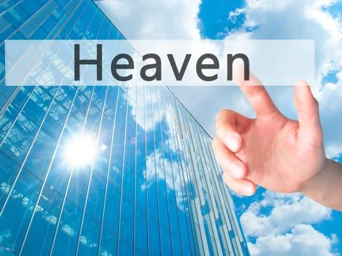 Heaven - Hand pressing a button on blurred background concept on visual scree Stock Photos