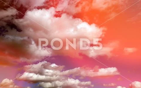 Heavenly background. white Cumulus clouds in the sunset orange sky Stock Photos