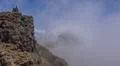 Heavenly clouds and thick fog on rocky mountain peak in La Palma island Photo