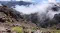 Heavenly clouds and yellow flowers on rocky mountain peak in La Palma island Photo