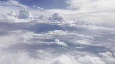 Heavenly clouds from a plane window in flight 4k 30fps Stock Footage 240357314