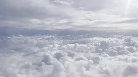 Heavenly clouds from a plane window in flight 4k 30fps Stock Footage 240359539