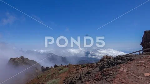 Heavenly clouds on rocky mountain peak in La Palma island Stock Photos
