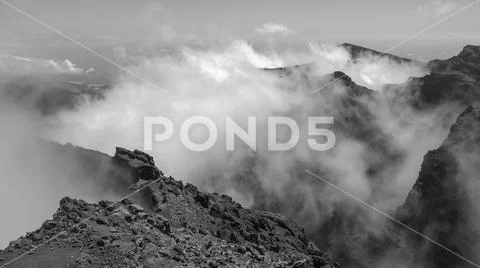 Heavenly clouds on rocky mountain peak in La Palma island Stock Photos