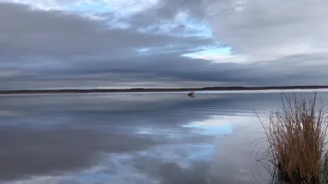 Heavenly cloudy landscape is reflected in the lake water Vídeos de archivo 319574228
