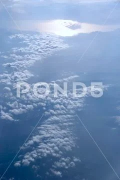 Heavenly landscape with shining sun. White clouds on blue sky Stock Photos