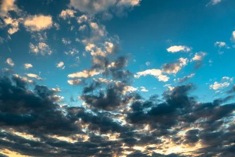 The heavenly light of the sun. Dramatic evening sky with clouds and rays of t Stock Photos