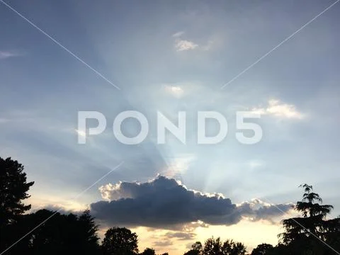 Heavenly rays of light shoot beams through clouds Stock Photos