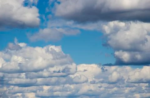 Heavenly sky between the white clouds and the radiant sun Stock Photos