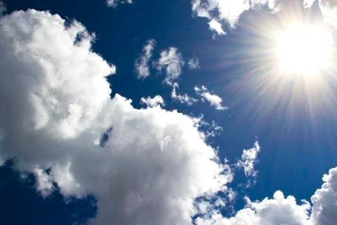 Heavenly sky between the white clouds and the radiant sun Stock Photos
