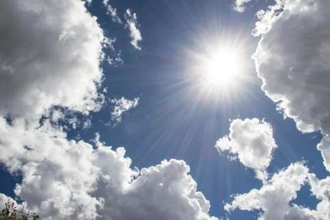 Heavenly sky between the white clouds and the radiant sun Stock Photos