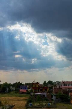 Heavenly Sun Rays Through Dark Clouds Against The Blue Sky. selective focus Stock Photos