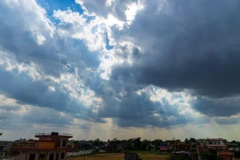 Heavenly Sun Rays Through Dark Clouds Against The Blue Sky. selective focus Stock Photos