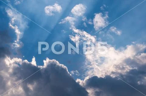 Heavenly sunrays through clouds Stock Photos