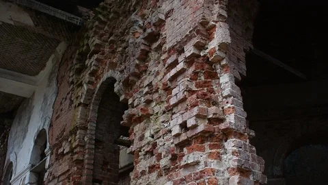 Heavily dilapidated brick wall with window openings, ruin Stock Footage 122237904