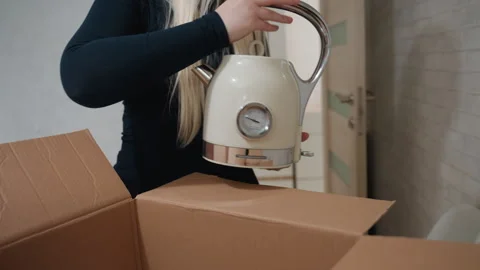 Heavily padded box protects delicate kitchenware items. Quietly organizing Stock Footage 345519813
