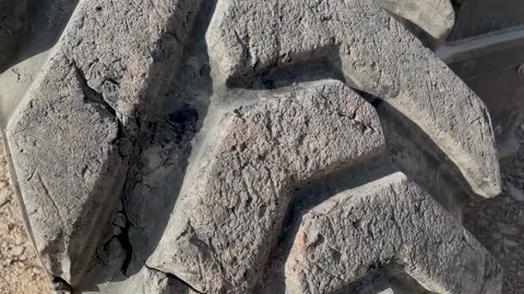 Heavily worn loader tire with deep tread. cuts and defects ha surface Stock Footage 239828547