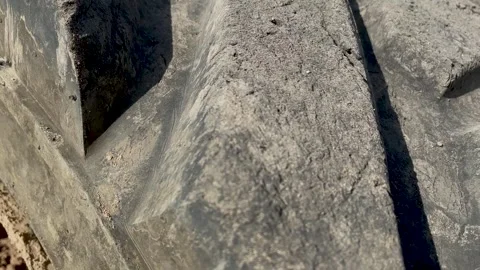 Heavily worn loader tire with deep tread. cuts and defects ha surface Stock Footage 246976994