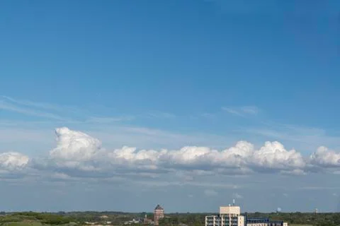 Heavy and compact group of clouds floating in the blue cyan pur gradient colo Фото