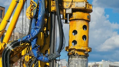 Heavy big excavator break trough holes concrete colones road construction site Stock Footage 100525404