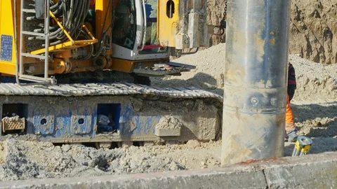 Heavy big excavator break trough holes concrete colones road construction site 動画素材 100525405