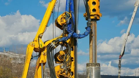 Heavy big excavator break trough holes concrete colones road construction site 動画素材 100525577