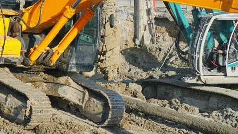 Heavy big excavator break trough holes concrete colones road construction site 動画素材 100525767