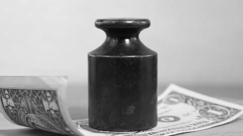 Heavy black weight is on the US dollar Stock Footage 308252112