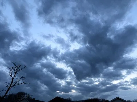 Heavy Blue Gray Storm Clouds Over Suburban Roofs 写真素材