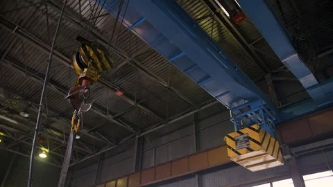 Heavy bridge crane with hook moving alongside the factory Stock Footage 84841114