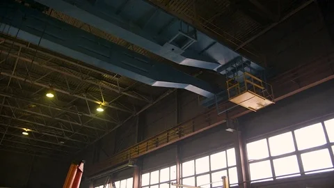 Heavy bridge crane moving alongside the factory Stock Footage 84841254