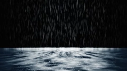 Heavy cinematic rain falling on a rippling water surface at night. 4K Video stock 345112124