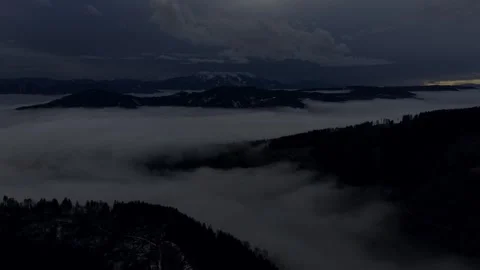 Heavy cloud ceiling over rolling mountain hills Stock Footage 328493867