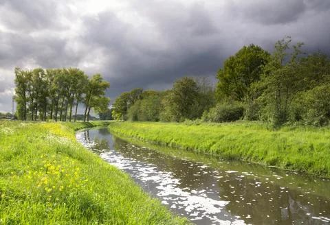 Heavy clouds above the river Aa near Heeswijk Stock Photos