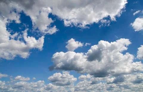 Heavy clouds in the deep blue summer sky Stock Photos
