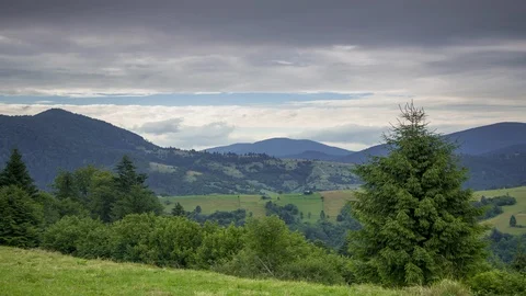 Heavy Clouds over Forested Mountains and Valleys. Time Lapse 動画素材 106457858