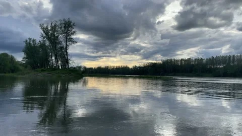 Heavy clouds over an island on the danube river Stock Footage 154339844