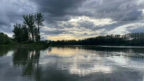 Heavy clouds over an island on the danube river Stock Footage 154339860