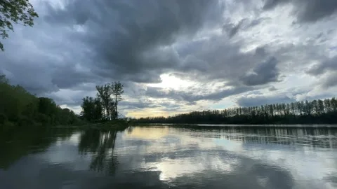 Heavy clouds over an island on the danube river Stock Footage 154339896