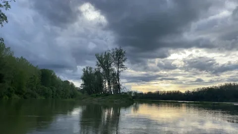 Heavy clouds over an island on the danube river Stock Footage 154339901