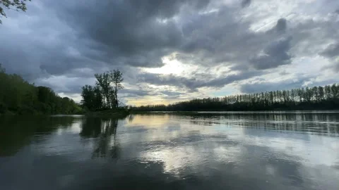 Heavy clouds over an island on the danube river Stock Footage 154339924