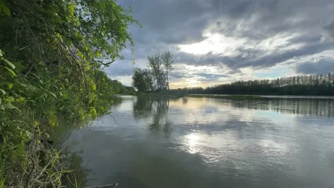 Heavy clouds over an island on the danube river Stock Footage 154339980