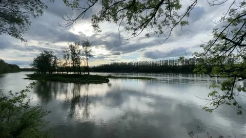 Heavy clouds over an island on the danube river Stock Footage 154340027