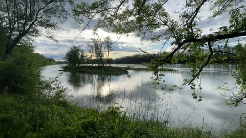 Heavy clouds over an island on the danube river Stock Footage 154340032