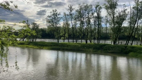 Heavy clouds over an island on the danube river Stock Footage 154340125