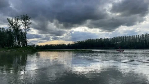 Heavy clouds over an island on the danube river near enns, upper austria Stock Footage 154340433