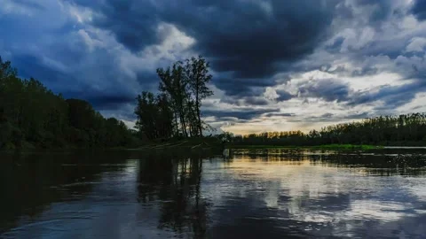 Heavy clouds over island on the danube river near enns, upper austria Stock Footage 154387634
