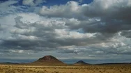 Heavy Clouds Roll Over Mountains In Desert Landscape, Time Lapse Stock Footage