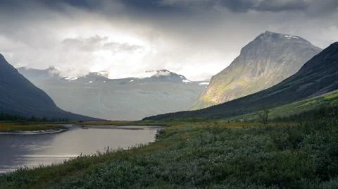 Heavy clouds rolling above remote arctic valley. Rapadalen, Sarek National Park Stock Photos